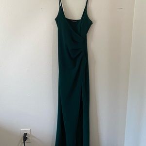 Long dark green fitted dress with a slit